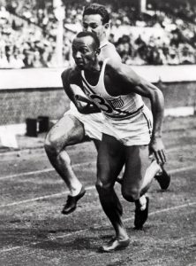 Jesse Owens and teammate competing in the 400 meter relay, Berlin Olympics, 1936